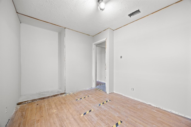 1315 Loral Ave, Joliet, IL 60435 - empty room with wood finished floors and a textured ceiling