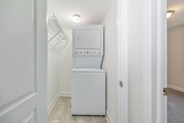 2109 N Harlem Ave Unit 3A, Chicago, IL 60707 - washroom featuring stacked washer / dryer and baseboards