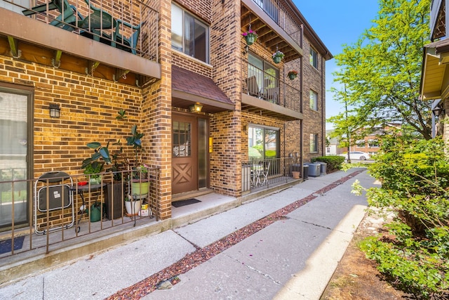 2109 N Harlem Ave Unit 3A, Chicago, IL 60707 - property entrance with brick siding, central AC, and a balcony