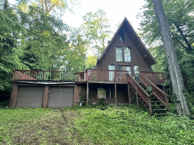 307 Northern Oaks Dr, Groveland, IL 61535 - rear view of house featuring a wooden deck, a garage, and stairway