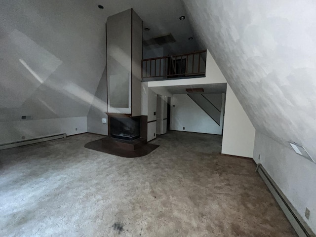 307 Northern Oaks Dr, Groveland, IL 61535 - unfurnished living room with vaulted ceiling, a wood stove, and baseboard heating