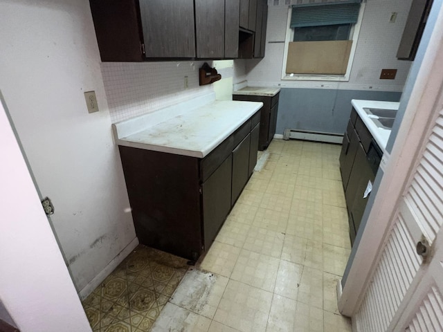 307 Northern Oaks Dr, Groveland, IL 61535 - kitchen featuring baseboard heating, light floors, decorative backsplash, light countertops, and baseboards
