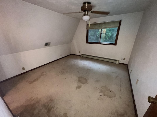 307 Northern Oaks Dr, Groveland, IL 61535 - additional living space with baseboard heating, a ceiling fan, concrete flooring, baseboards, and vaulted ceiling