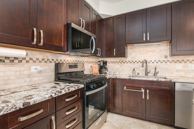1705 Pavilion Way Unit 401, Park Ridge, IL 60068 - kitchen with stainless steel appliances, a sink, light stone counters, and decorative backsplash