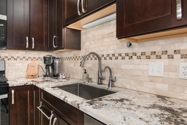 1705 Pavilion Way Unit 401, Park Ridge, IL 60068 - kitchen with a sink, backsplash, dark brown cabinetry, and light stone countertops