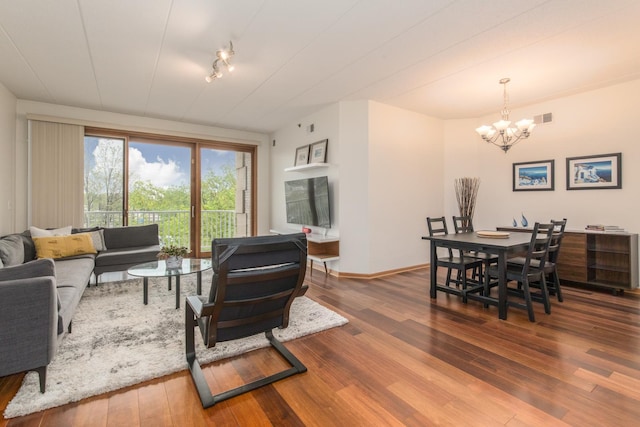 1705 Pavilion Way Unit 401, Park Ridge, IL 60068 - living room featuring a chandelier, hardwood / wood-style floors, rail lighting, and baseboards