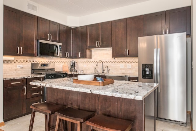 1705 Pavilion Way Unit 401, Park Ridge, IL 60068 - kitchen with appliances with stainless steel finishes, a sink, light tile patterned floors, and light stone counters