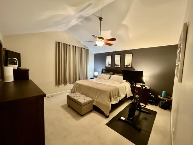 1676 Fredericksburg Ln, Aurora, IL 60503 - bedroom featuring carpet flooring, vaulted ceiling, and a ceiling fan