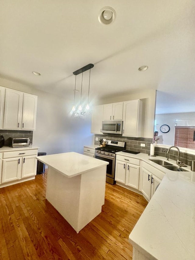 1676 Fredericksburg Ln, Aurora, IL 60503 - kitchen with stainless steel appliances, backsplash, white cabinetry, and recessed lighting