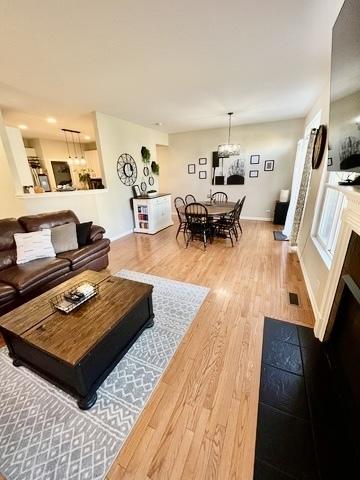 1676 Fredericksburg Ln, Aurora, IL 60503 - living area with wood finished floors and a chandelier