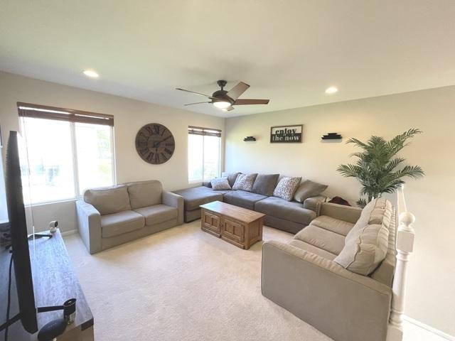 1676 Fredericksburg Ln, Aurora, IL 60503 - living area featuring ceiling fan, light carpet, and recessed lighting