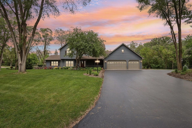 2902 Pleasant Dr, Mchenry, IL 60051 - view of front of house with a garage, a front yard, and asphalt driveway