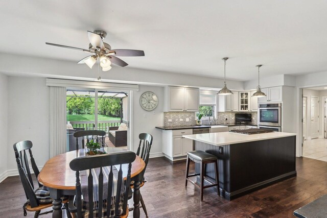 2902 Pleasant Dr, Mchenry, IL 60051 - dining area with a ceiling fan, baseboards, and dark wood-style floors