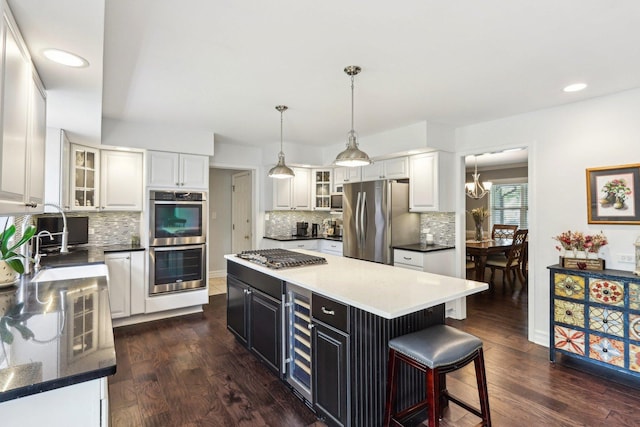 2902 Pleasant Dr, Mchenry, IL 60051 - kitchen with appliances with stainless steel finishes, white cabinetry, beverage cooler, decorative backsplash, and recessed lighting