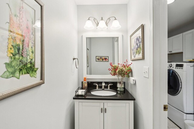 2902 Pleasant Dr, Mchenry, IL 60051 - bathroom featuring washer / dryer, vanity, and a chandelier