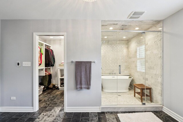2902 Pleasant Dr, Mchenry, IL 60051 - bathroom with a soaking tub, a shower stall, a walk in closet, baseboards, and recessed lighting
