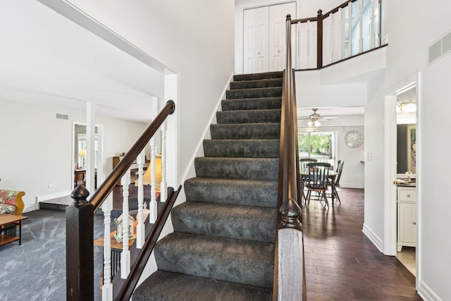 2902 Pleasant Dr, Mchenry, IL 60051 - staircase featuring hardwood / wood-style flooring, baseboards, a ceiling fan, and a towering ceiling