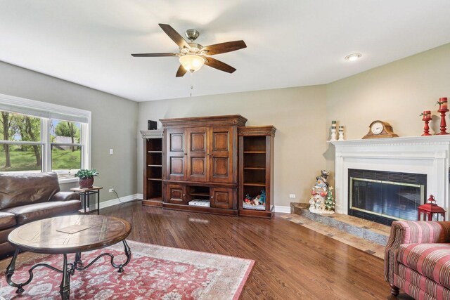 2902 Pleasant Dr, Mchenry, IL 60051 - living area featuring a ceiling fan, baseboards, wood finished floors, and a glass covered fireplace