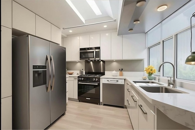 1720 Maple Ave Unit 1270, Evanston, IL 60201 - kitchen featuring appliances with stainless steel finishes, a sink, modern cabinets, white cabinetry, and light countertops