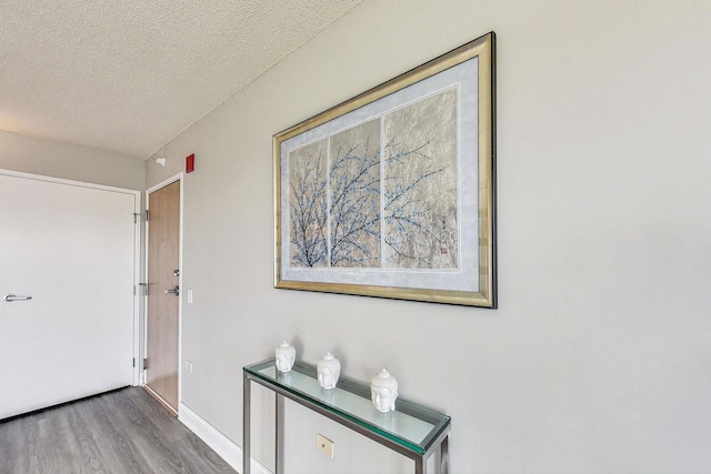 1720 Maple Ave Unit 1270, Evanston, IL 60201 - corridor featuring wood finished floors, a textured ceiling, and baseboards