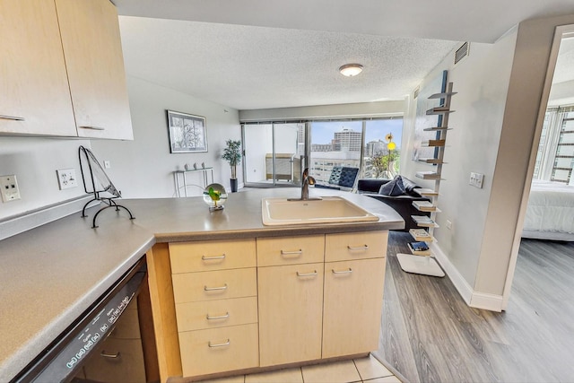 1720 Maple Ave Unit 1270, Evanston, IL 60201 - kitchen with light brown cabinetry, a sink, dishwasher, a peninsula, and light wood-style flooring