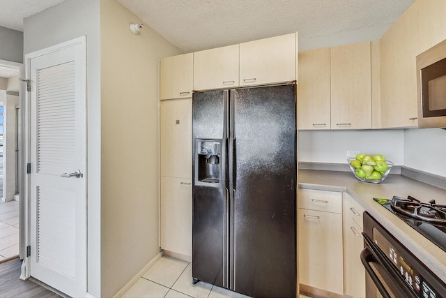 1720 Maple Ave Unit 1270, Evanston, IL 60201 - kitchen with black appliances, light tile patterned floors, light countertops, and a textured ceiling