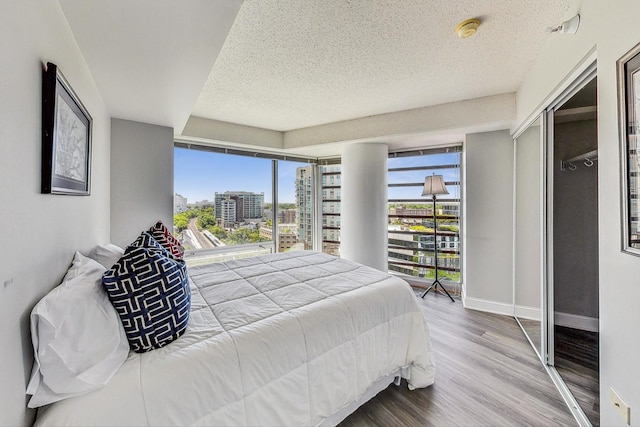 1720 Maple Ave Unit 1270, Evanston, IL 60201 - bedroom with a view of city, a textured ceiling, wood finished floors, and baseboards