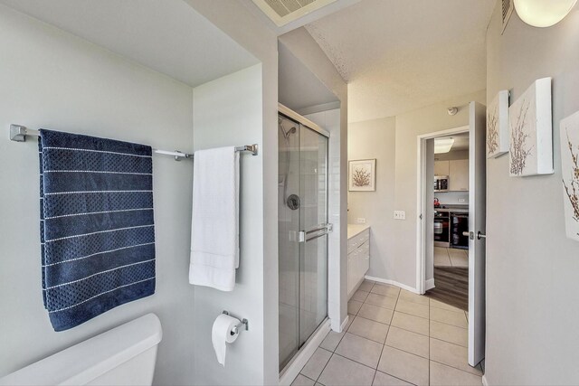 1720 Maple Ave Unit 1270, Evanston, IL 60201 - bathroom with toilet, tile patterned floors, a shower stall, vanity, and baseboards