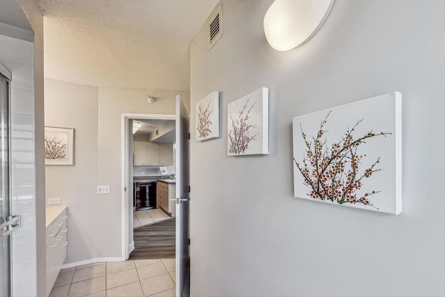 1720 Maple Ave Unit 1270, Evanston, IL 60201 - hallway with light tile patterned floors, baseboards, and a textured ceiling