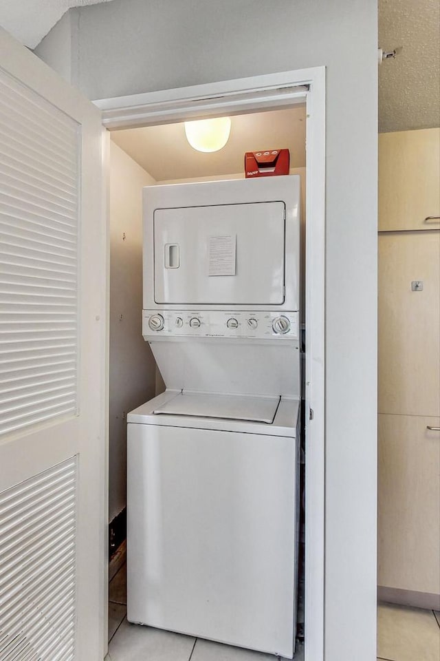 1720 Maple Ave Unit 1270, Evanston, IL 60201 - laundry area with stacked washer / dryer and light tile patterned flooring