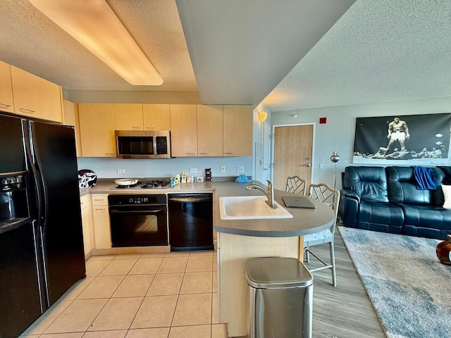 1720 Maple Ave Unit 1270, Evanston, IL 60201 - kitchen with black appliances, a sink, light brown cabinets, a peninsula, and a textured ceiling