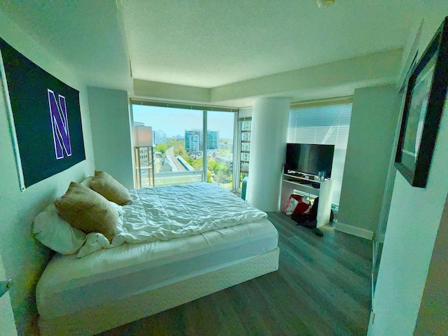 1720 Maple Ave Unit 1270, Evanston, IL 60201 - bedroom with wood finished floors, a textured ceiling, and baseboards