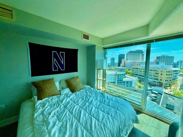 1720 Maple Ave Unit 1270, Evanston, IL 60201 - bedroom with a view of city, a textured ceiling, and wood finished floors