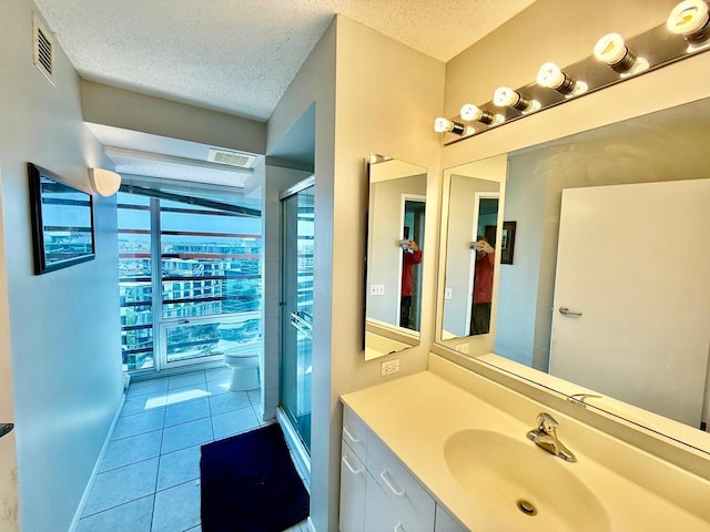 1720 Maple Ave Unit 1270, Evanston, IL 60201 - bathroom featuring vanity, a shower stall, tile patterned floors, and a textured ceiling