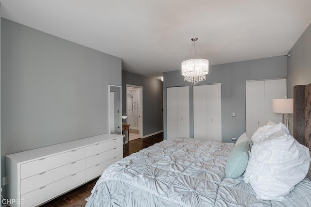 330 W Grand Ave Unit 2002, Chicago, IL 60654 - bedroom with two closets, a chandelier, dark wood finished floors, and ensuite bath