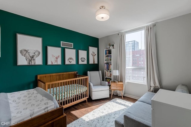 330 W Grand Ave Unit 2002, Chicago, IL 60654 - bedroom featuring wood finished floors, a crib, and baseboards