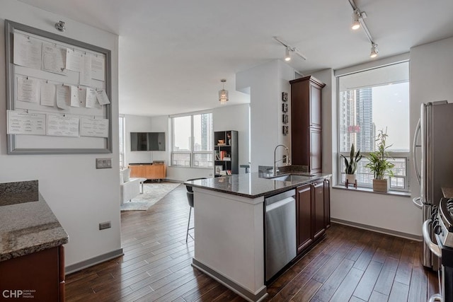 330 W Grand Ave Unit 2002, Chicago, IL 60654 - kitchen with stainless steel appliances, a sink, rail lighting, open floor plan, and dark wood-style floors