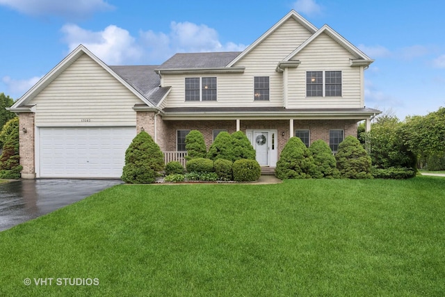 17083 W Tiger Tail Ct, Gurnee, IL 60031 - view of front of property featuring asphalt driveway, a front yard, brick siding, and a garage
