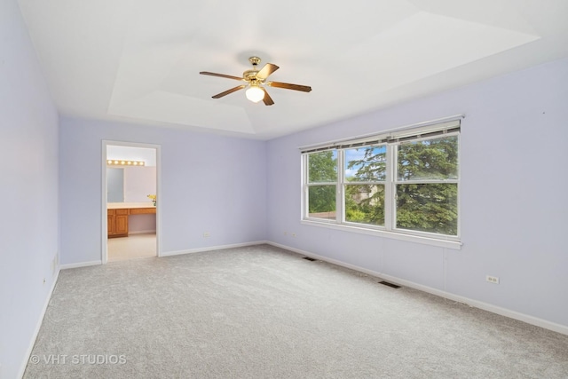 17083 W Tiger Tail Ct, Gurnee, IL 60031 - unfurnished room with a tray ceiling, a ceiling fan, carpet, and baseboards