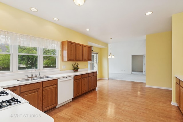 17083 W Tiger Tail Ct, Gurnee, IL 60031 - kitchen featuring white dishwasher, a sink, light wood-style flooring, brown cabinetry, and light countertops