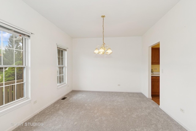17083 W Tiger Tail Ct, Gurnee, IL 60031 - carpeted empty room with a chandelier and baseboards