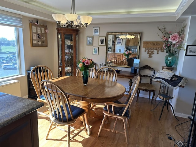 7033 N Kedzie Ave Unit 301, Chicago, IL 60645 - dining space featuring a chandelier, light wood-type flooring, a raised ceiling, and ornamental molding