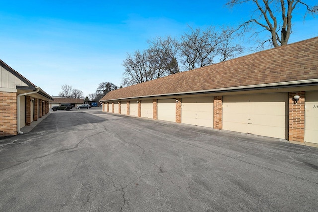 1116 S New Wilke Rd Unit 408, Arlington Heights, IL 60005 - view of asphalt road featuring community garages