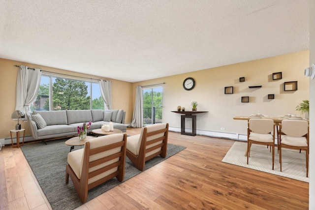 1116 S New Wilke Rd Unit 408, Arlington Heights, IL 60005 - living area featuring a baseboard radiator, a textured ceiling, light wood-style flooring, and baseboards