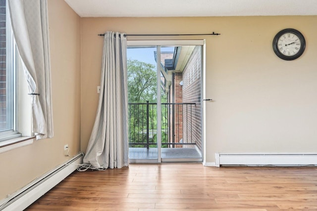 1116 S New Wilke Rd Unit 408, Arlington Heights, IL 60005 - empty room featuring a baseboard radiator and wood finished floors