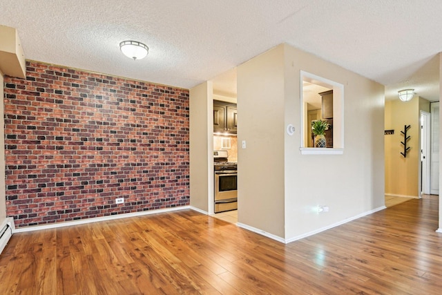 1116 S New Wilke Rd Unit 408, Arlington Heights, IL 60005 - spare room with light wood-type flooring, a textured ceiling, baseboards, and baseboard heating