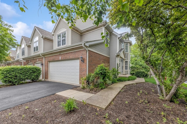 6173 Dixon Dr, Lisle, IL 60532 - view of side of home with an attached garage, asphalt driveway, and brick siding