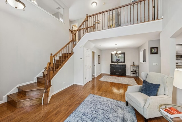 6173 Dixon Dr, Lisle, IL 60532 - living area featuring wood finished floors, stairway, arched walkways, baseboards, and a high ceiling