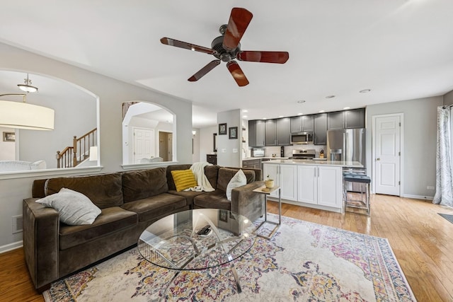 6173 Dixon Dr, Lisle, IL 60532 - living area featuring a ceiling fan, light wood-type flooring, arched walkways, and baseboards