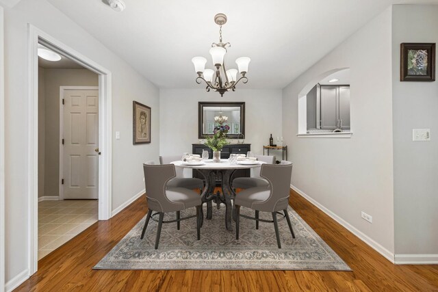 6173 Dixon Dr, Lisle, IL 60532 - dining room with a chandelier, wood finished floors, and baseboards